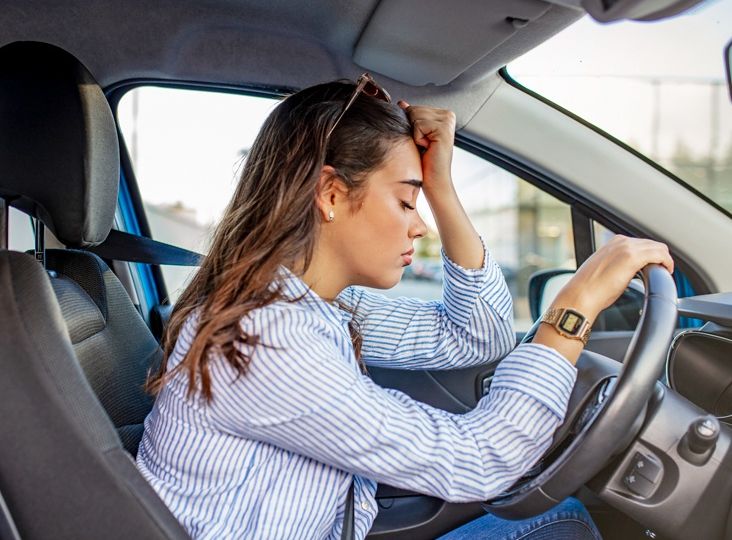 Stressed woman drive car feeling sad and angry.